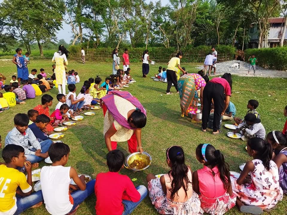 Children being served nutritious meals outdoors